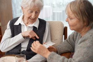 90-year-old-lady-at-home-with-her-carer-choosing-medication-this-file-has-a-professional-witnessed_t20_6y1jP6